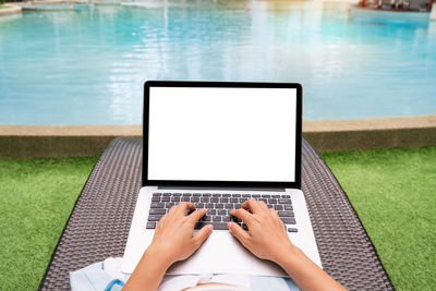 Midsection of woman using laptop