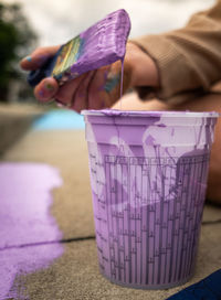 Close-up of hand holding purple paper