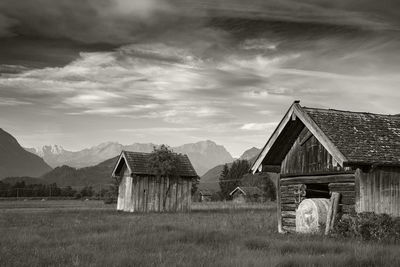 Abandoned house on field against sky