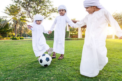 Low angle view of cute boys playing at park