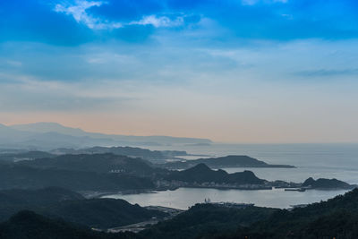 Scenic view of mountains against cloudy sky