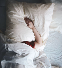 High angle view of woman sleeping on bed at home