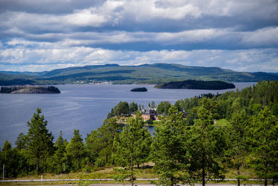 Scenic view of sea and mountains against sky