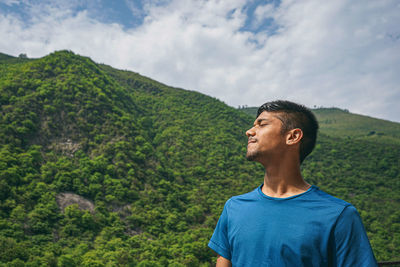 Man standing on mountain against sky