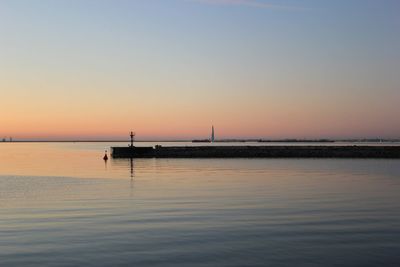 Scenic view of sea against clear sky during sunset