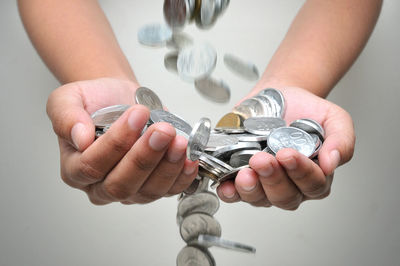 Close-up of hand holding with coins