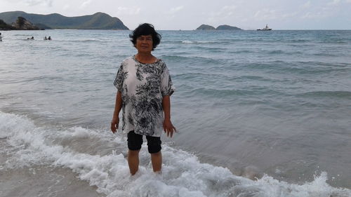 Portrait of woman standing on beach