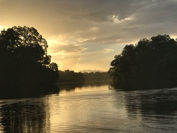 Scenic view of lake against sky at sunset