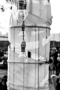 Close-up of light bulb hanging on street