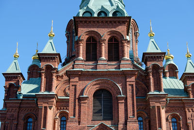 Low angle view of buildings against blue sky