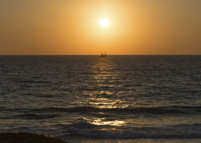 Scenic view of sea against clear sky during sunset