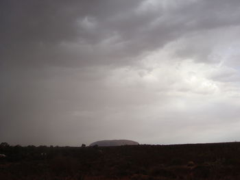 Silhouette of landscape against cloudy sky