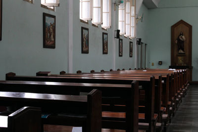 Empty chairs and table in building