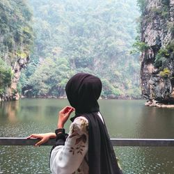 Rear view of woman looking at lake