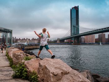 Full length of man on bridge over river