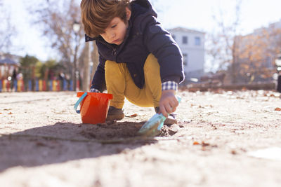 Boy playing on sand