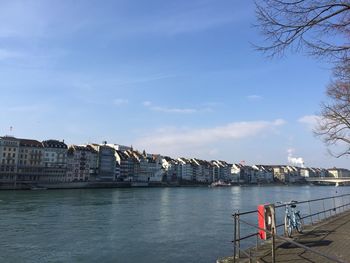 Bridge over river against buildings in city