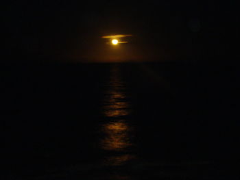 Scenic view of sea against sky at night