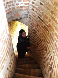 Portrait of a woman standing on stairs