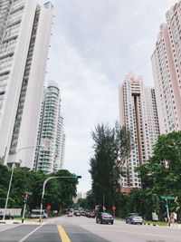 View of city street and buildings against sky