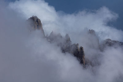 Scenic view of mountains against cloudy sky