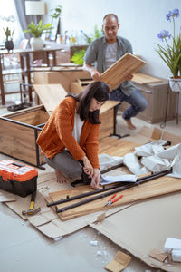 Couple assembling furniture at home