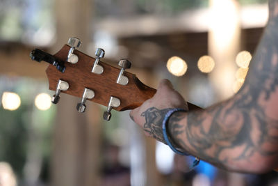 Close-up of man playing guitar
