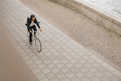 Full length of woman riding bicycle