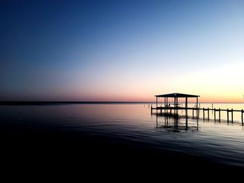 Scenic view of sea against clear sky during sunset