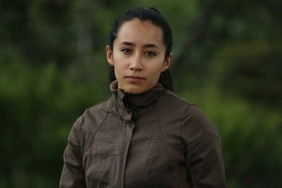 Close-up portrait of young woman standing outdoors