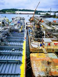 High angle view of a vessel moored at a maritime terminal against sky