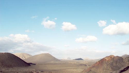 Scenic view of mountains against cloudy sky