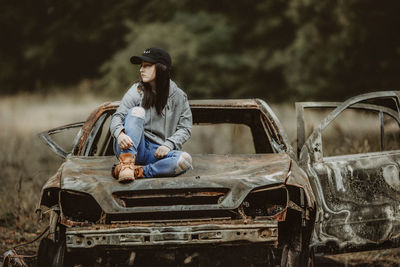 Full length of woman sitting in car