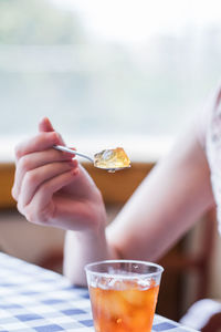Midsection of woman holding jelly