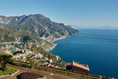 High angle view of buildings by sea against sky