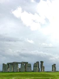 Built structure on field against sky