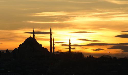 Silhouette tower against sky during sunset