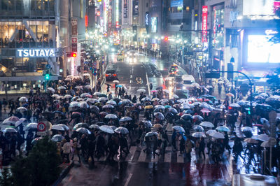 Crowd with umbrellas on city street