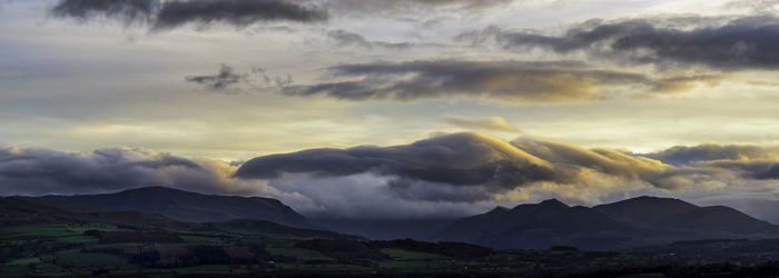 Scenic view of mountains against dramatic sky