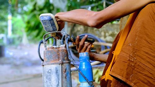 Close-up of person holding metal