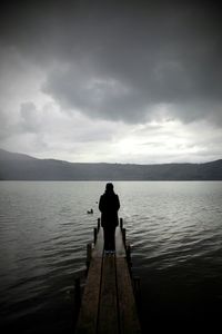 Man standing on pier