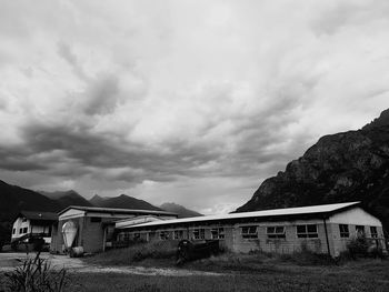 Houses against cloudy sky