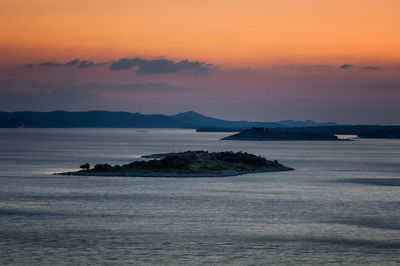 Scenic view of sea against romantic sky at sunset