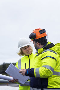 People talking on building site