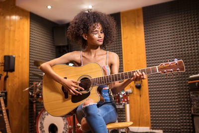 Young woman playing guitar