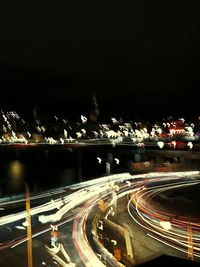 Light trails on road in city at night
