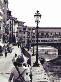 Man in city against sky