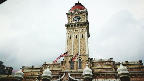 Low angle view of clock tower against sky