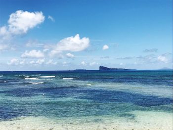 Scenic view of sea against blue sky