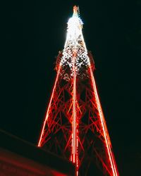Low angle view of illuminated christmas tree against sky at night